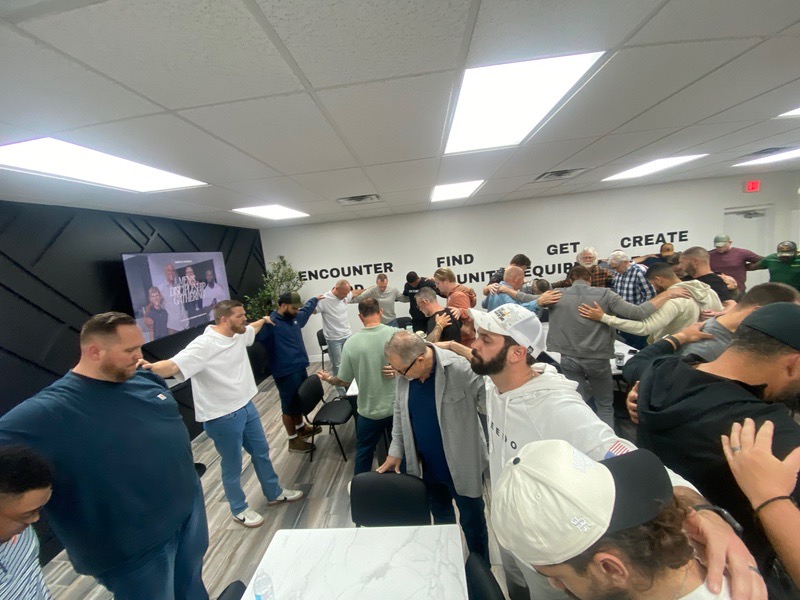Men's discipleship group praying together