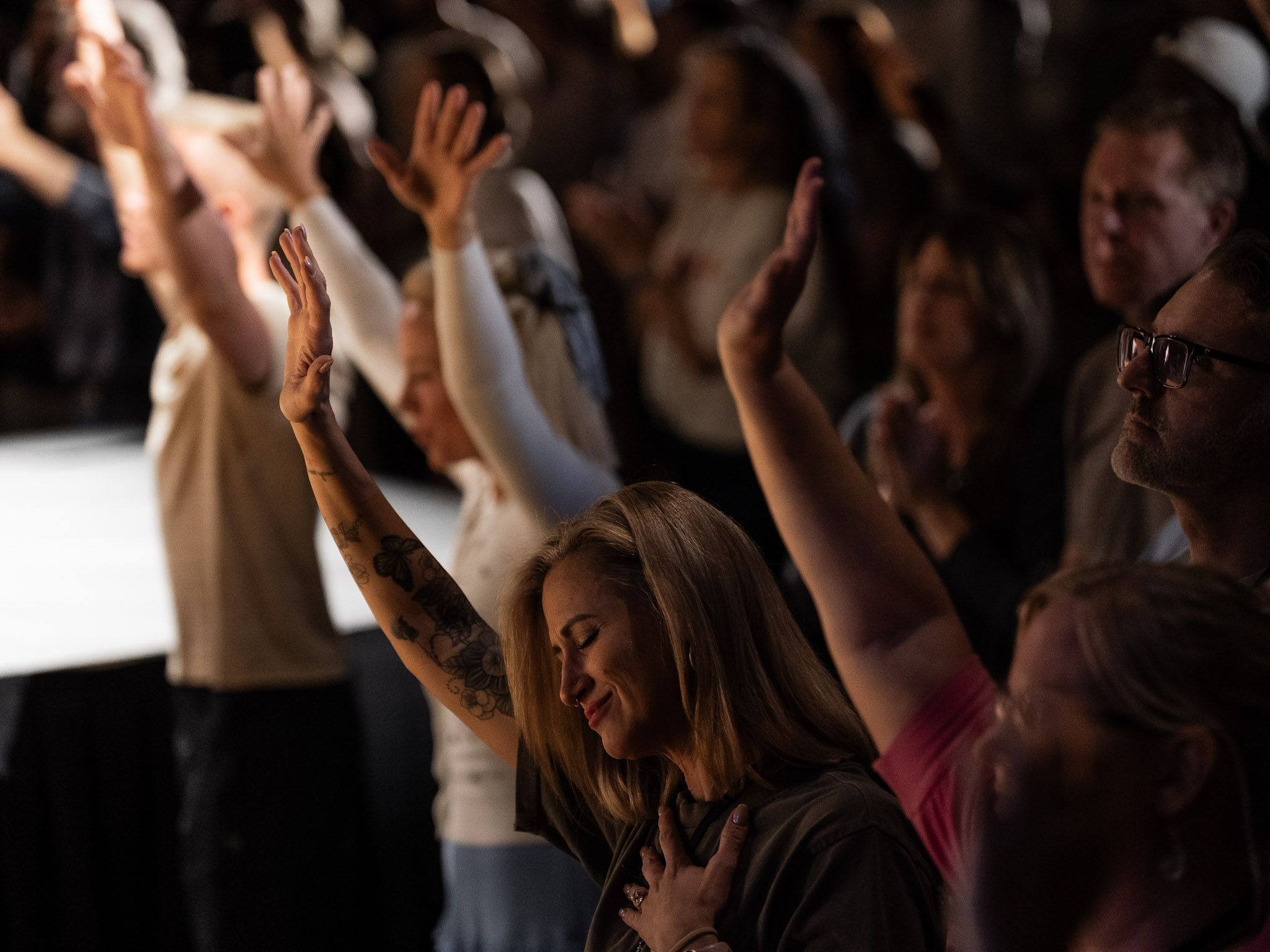 Woman worshipping with hands raised